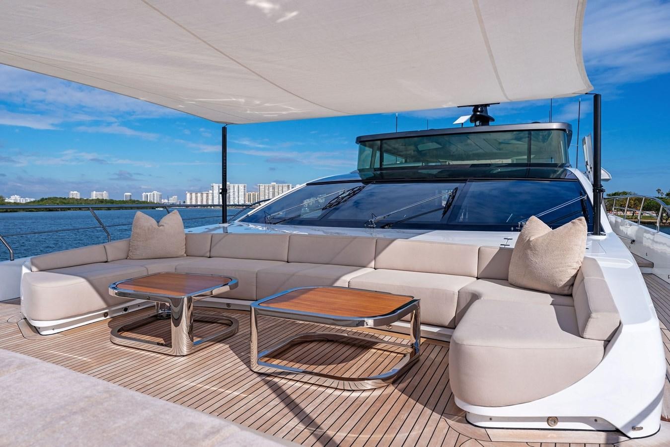 a luxury car with a table and chairs on a deck aboard LADY K Yacht for Sale