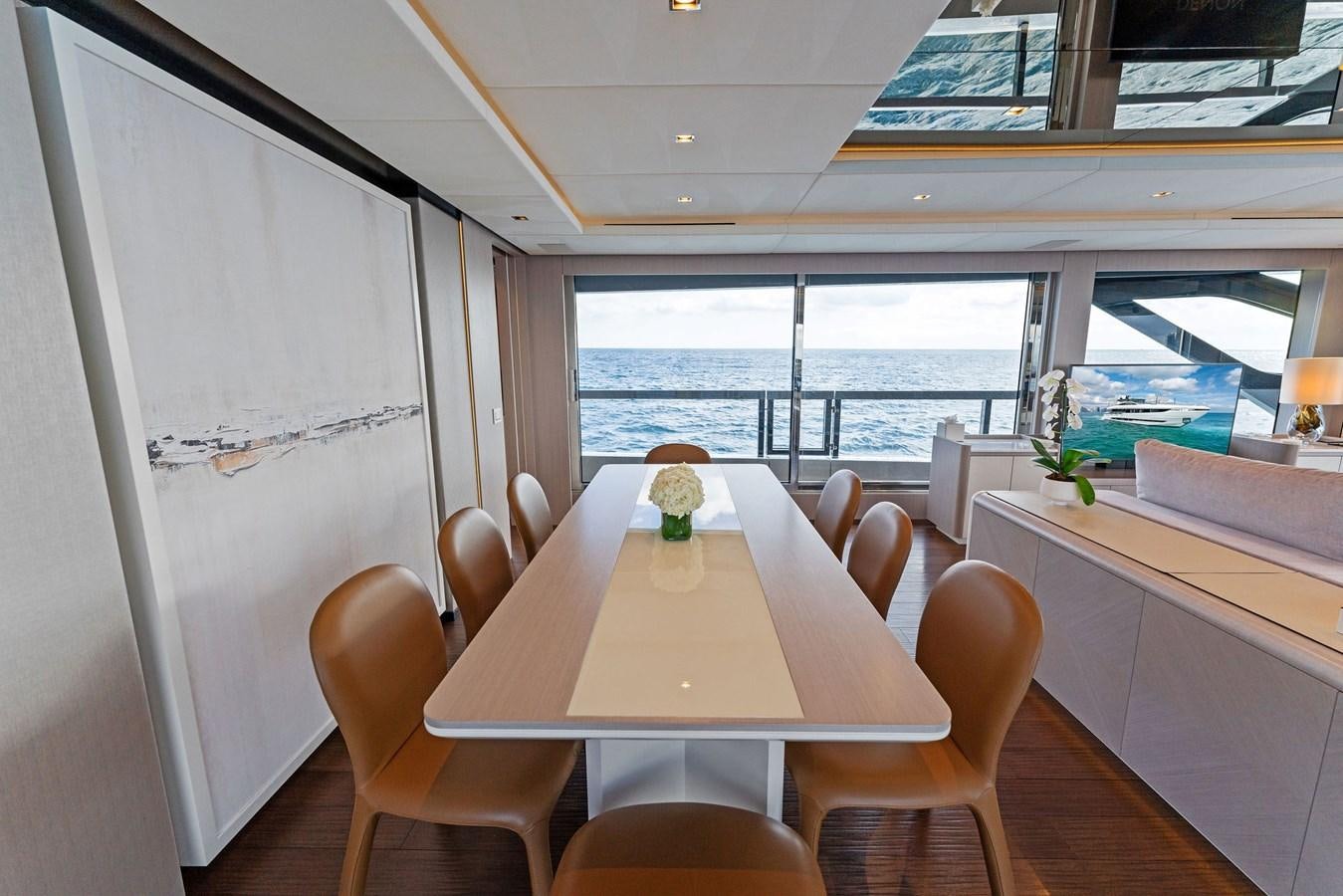 a room with tables and chairs aboard LADY K Yacht for Sale