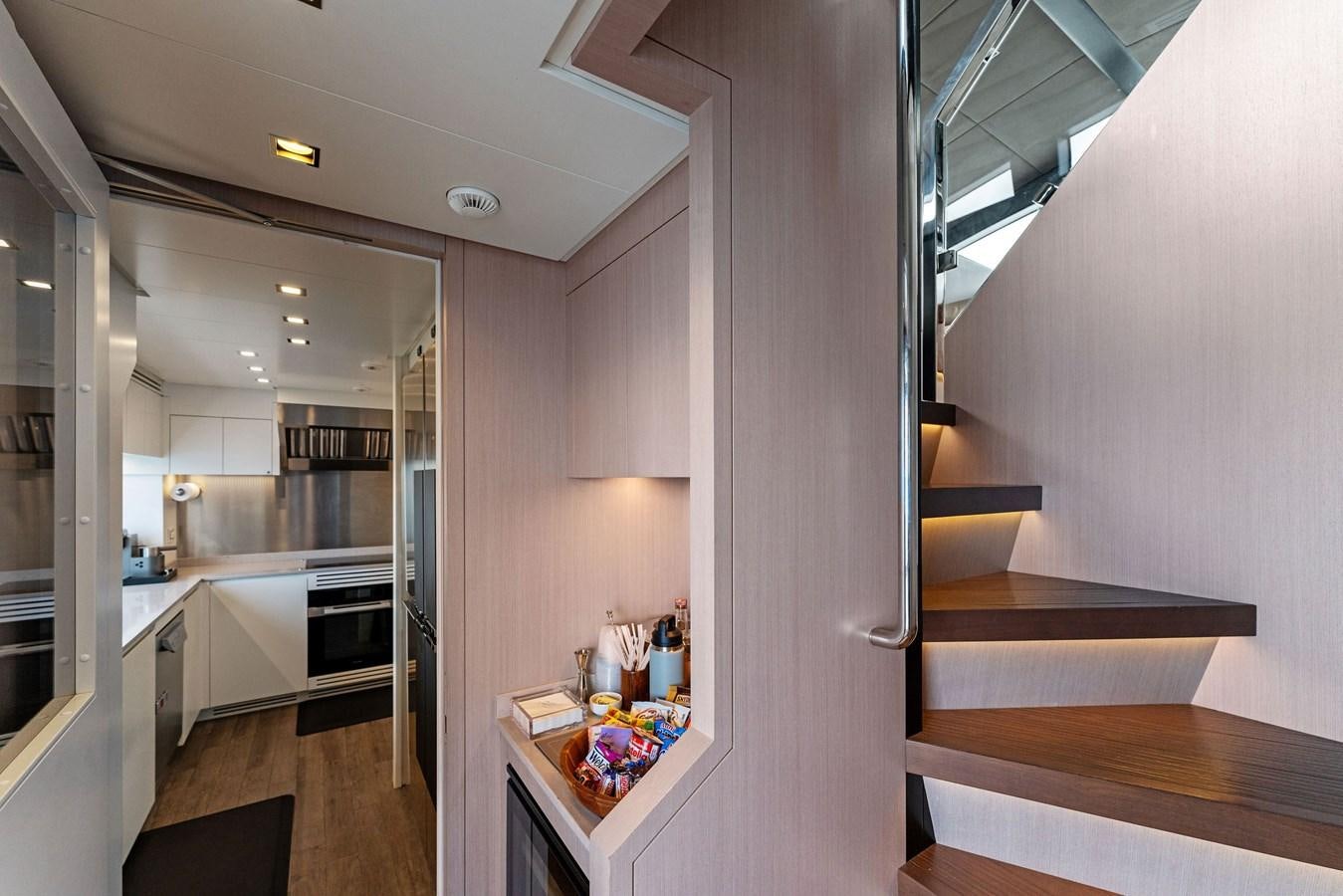 a room with a staircase and a table aboard LADY K Yacht for Sale