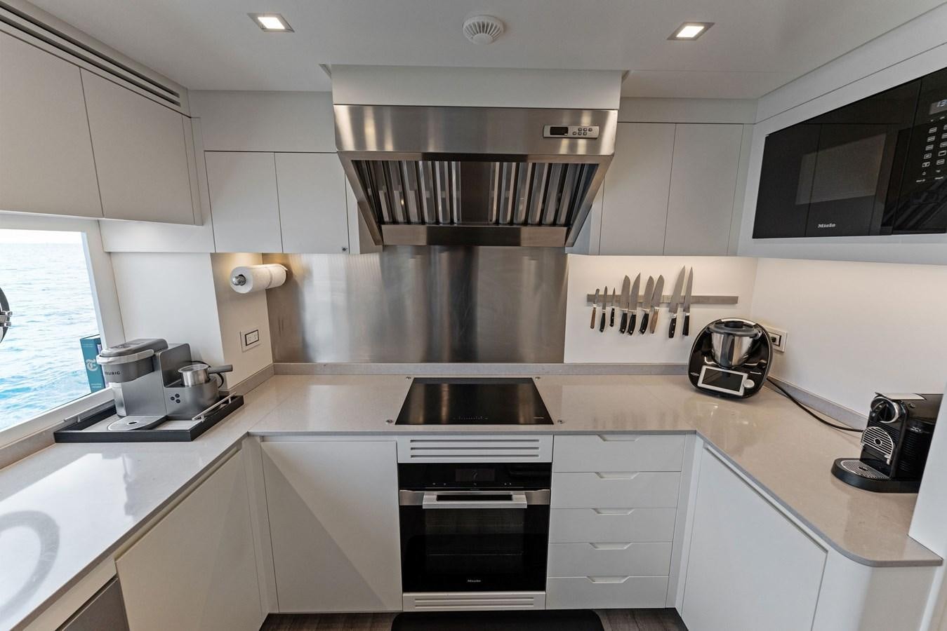 a kitchen with white cabinets aboard LADY K Yacht for Sale