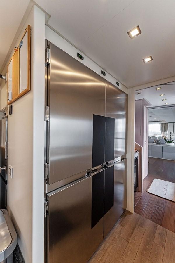 a stainless steel refrigerator in a kitchen aboard LADY K Yacht for Sale