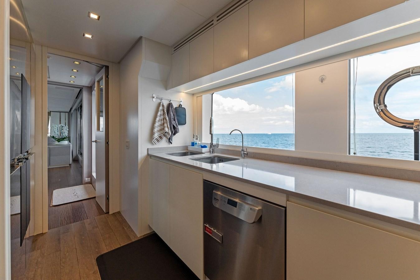 a kitchen with a large window aboard LADY K Yacht for Sale