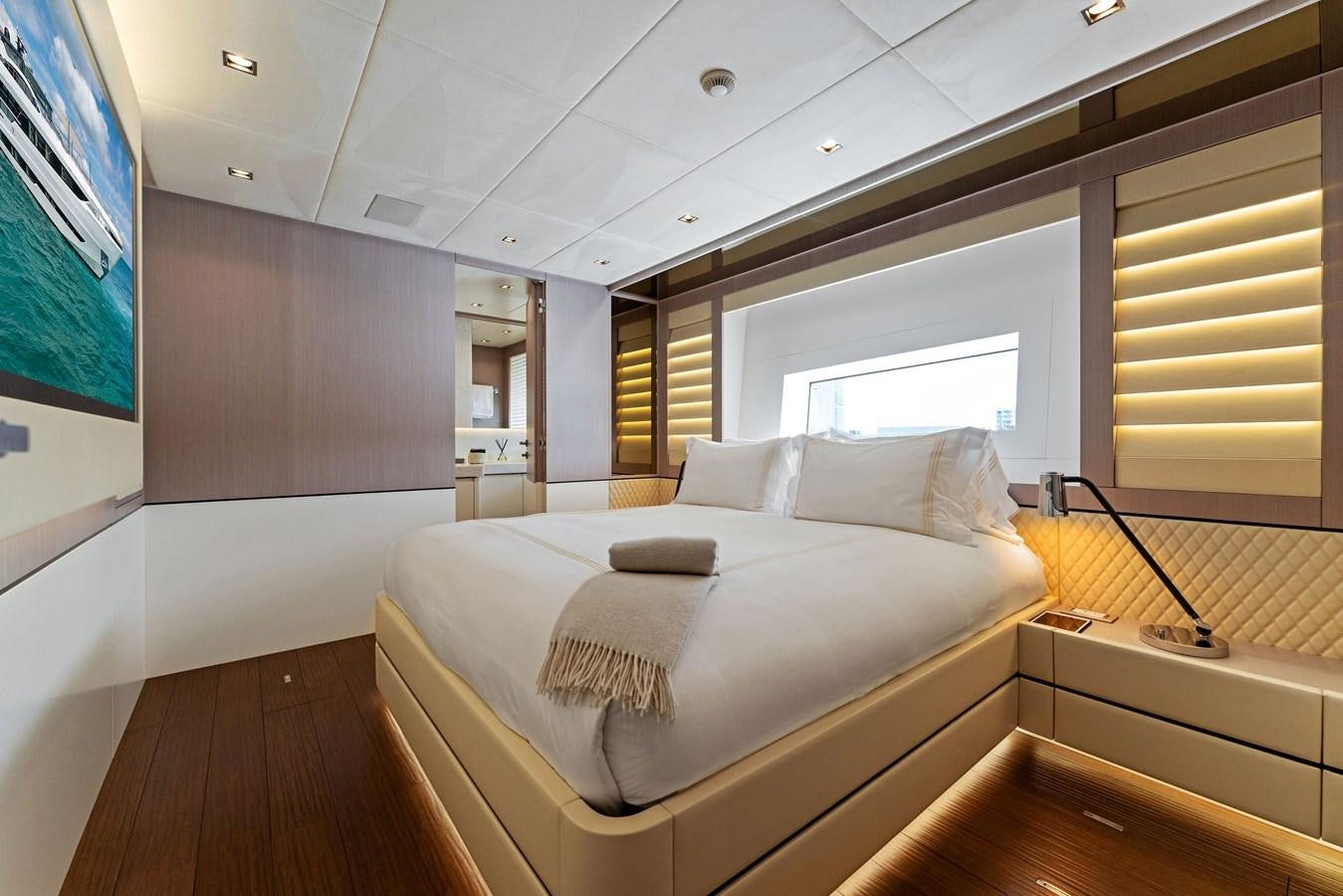 a room with a bed and a television aboard LADY K Yacht for Sale