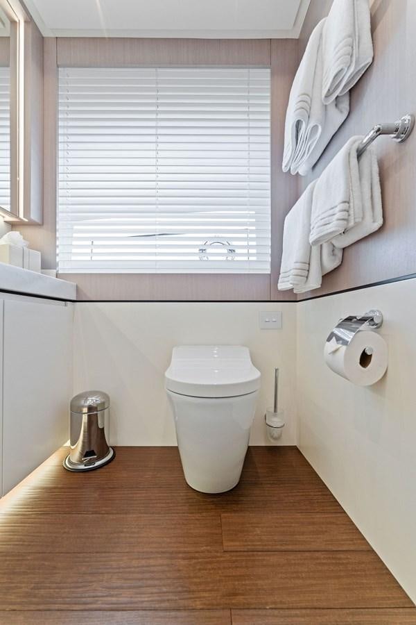 a bathroom with a toilet and towels aboard LADY K Yacht for Sale