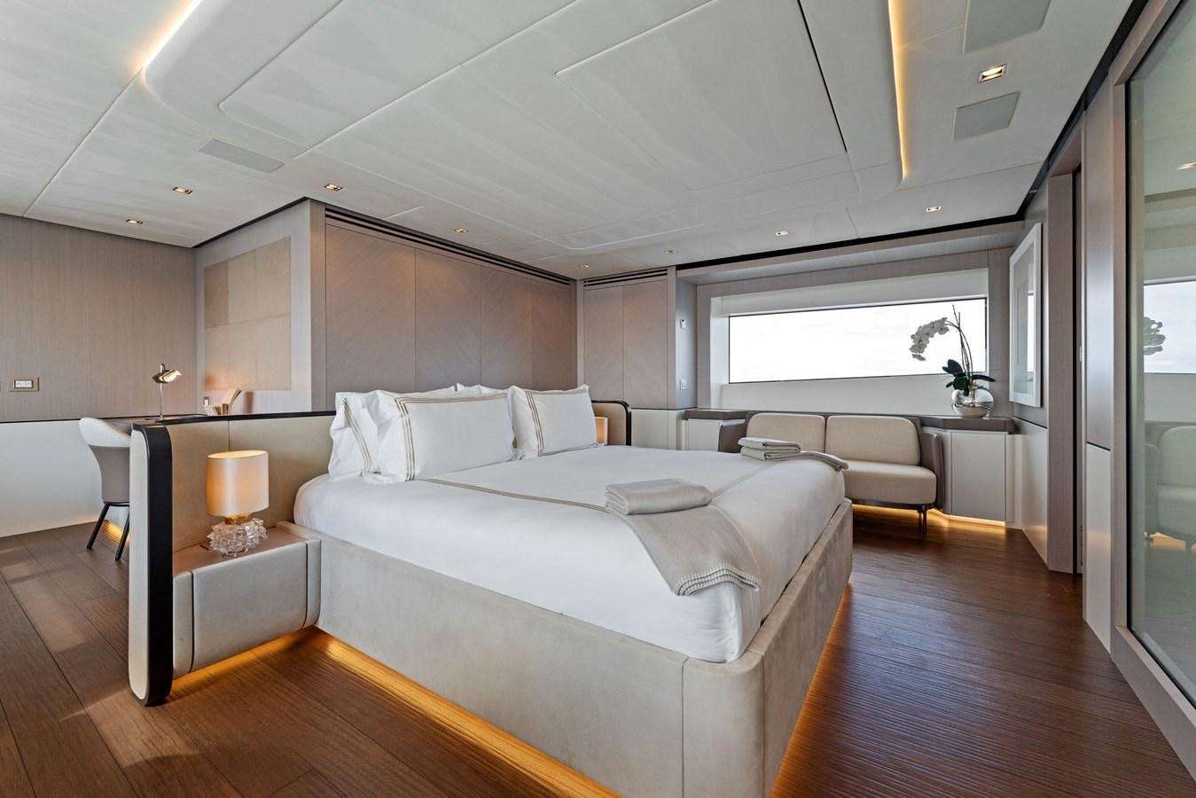 a bedroom with a bed and a desk aboard LADY K Yacht for Sale