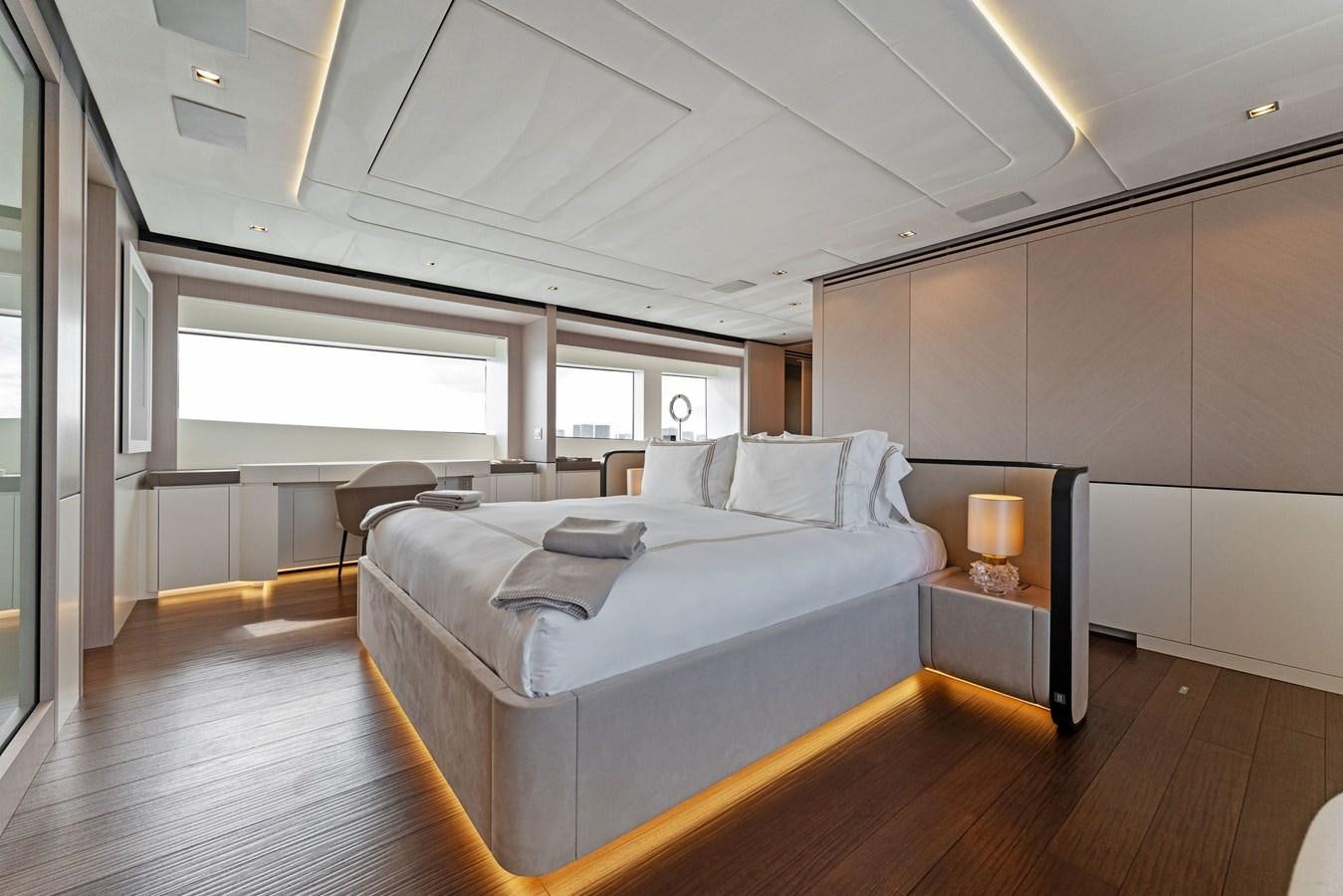 a bedroom with a bed and a table aboard LADY K Yacht for Sale