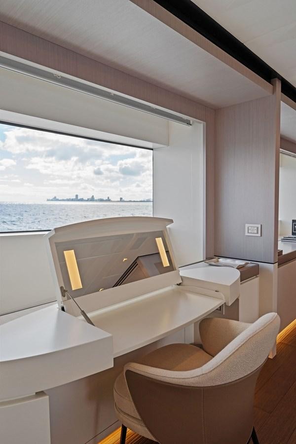 a room with a bed and a chair aboard LADY K Yacht for Sale