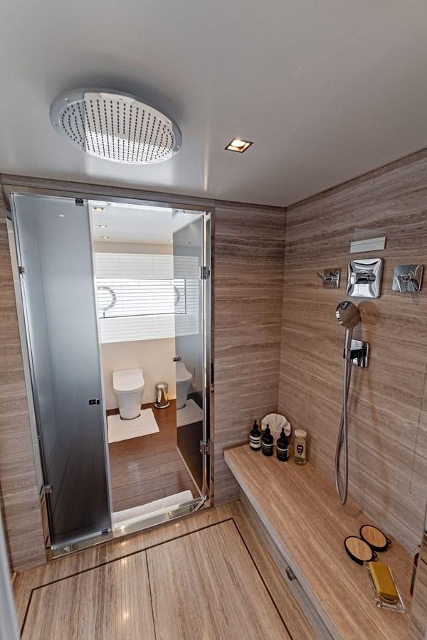 a bathroom with a shower unit and a mirror aboard LADY K Yacht for Sale