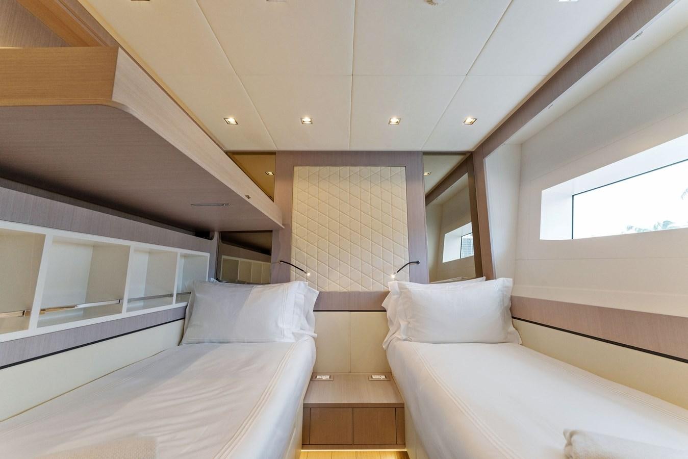 a room with several beds aboard LADY K Yacht for Sale