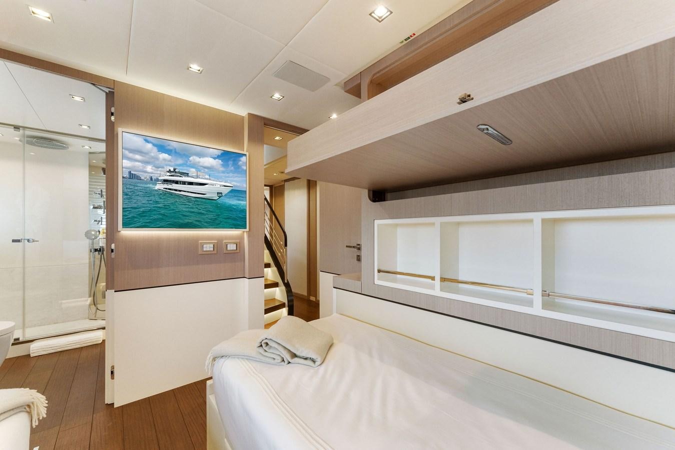 a bedroom with a large screen aboard LADY K Yacht for Sale