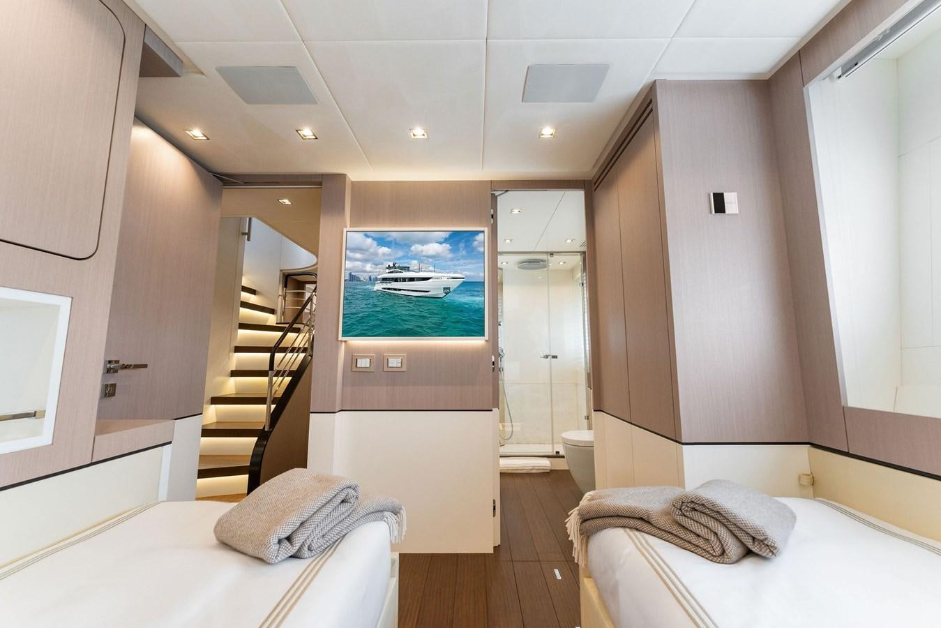 a room with a bed and a television aboard LADY K Yacht for Sale