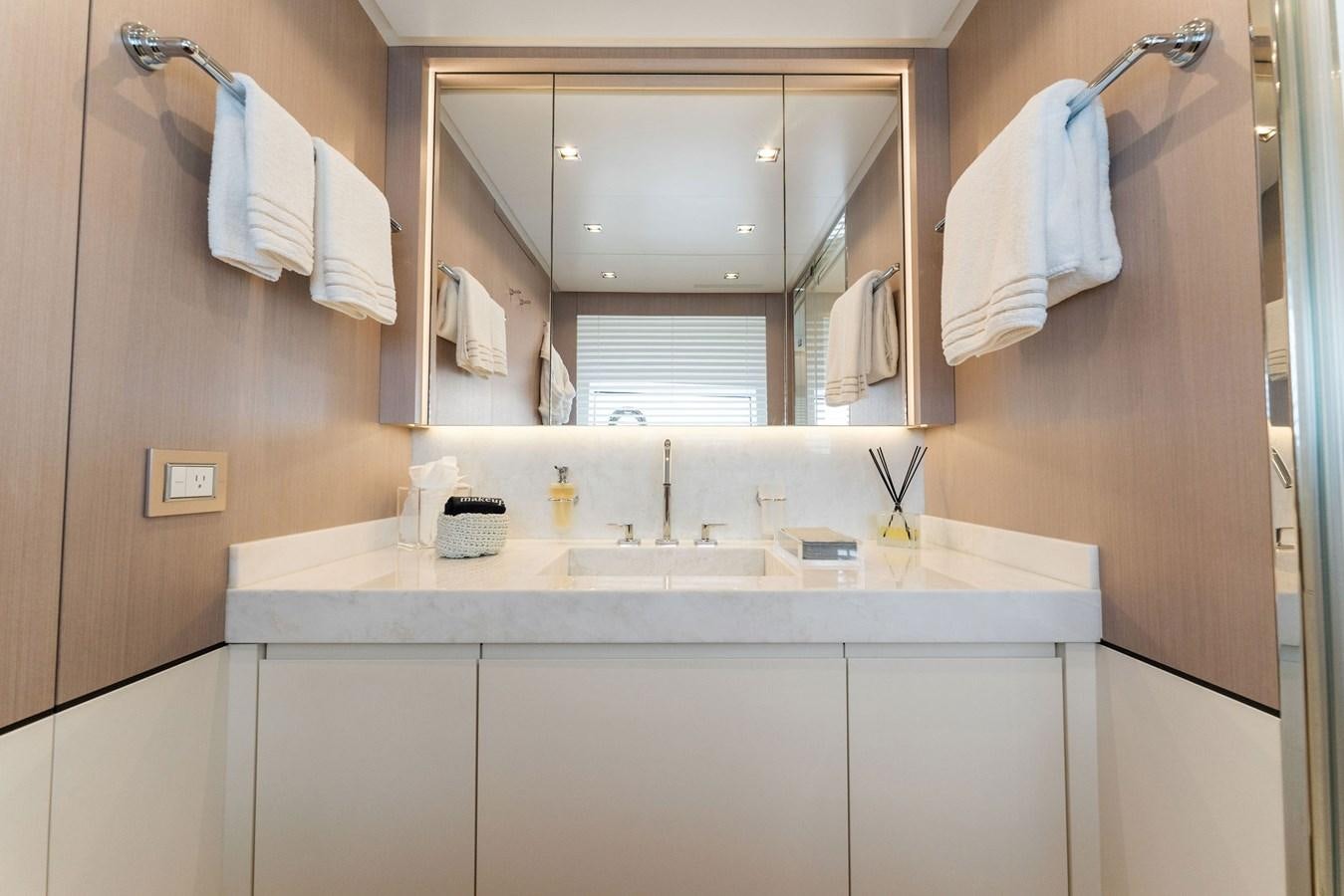 a bathroom with a mirror and a sink aboard LADY K Yacht for Sale