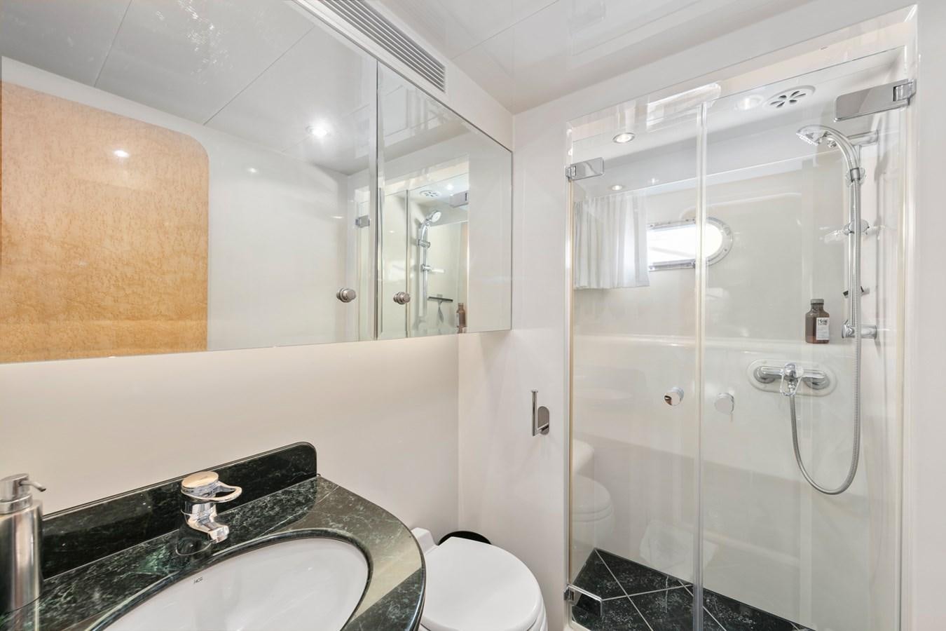 a bathroom with a glass shower aboard VAMOS A VER Yacht for Sale