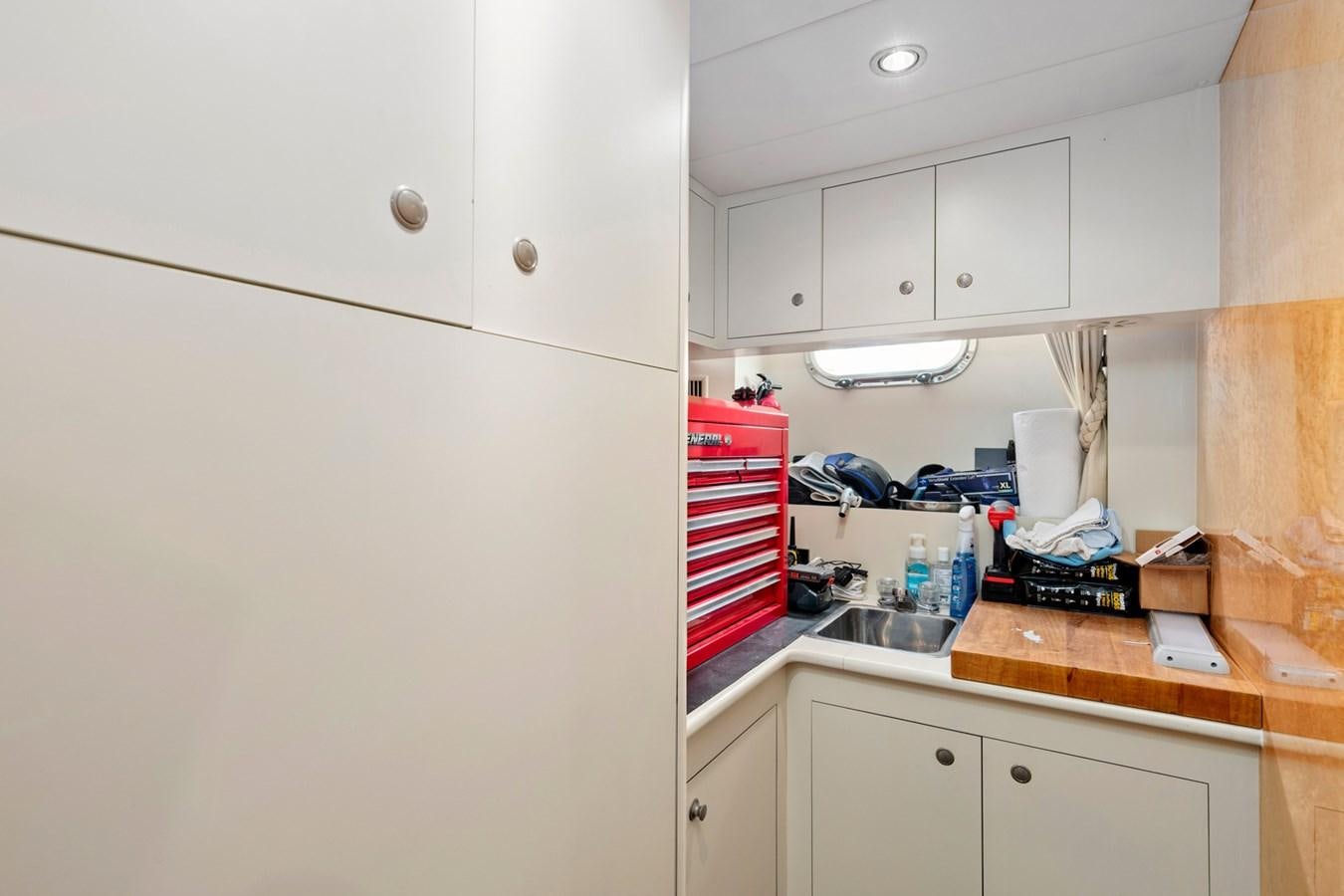 a kitchen with white cabinets aboard VAMOS A VER Yacht for Sale