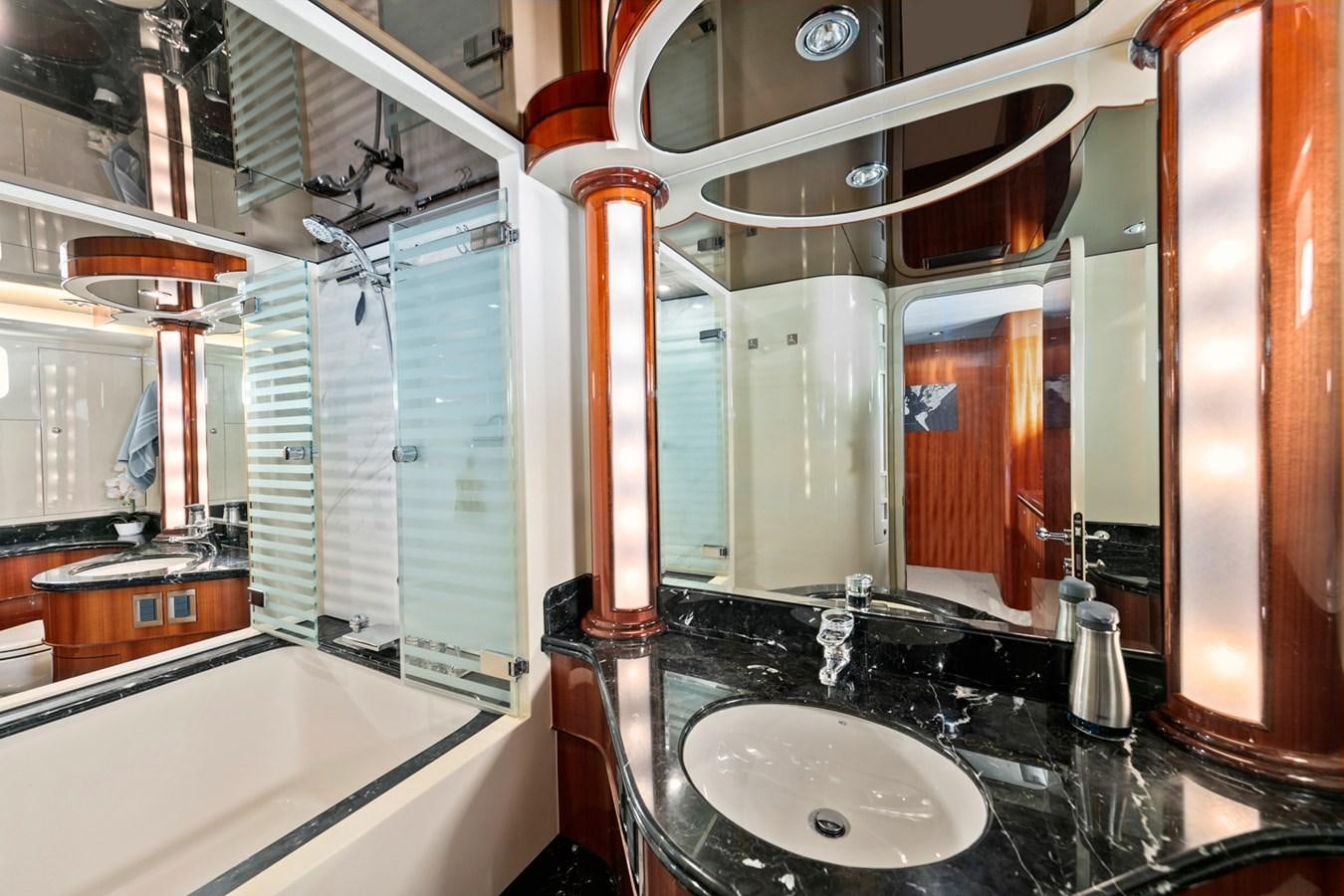 a bathroom with a sink and a large mirror aboard VAMOS A VER Yacht for Sale