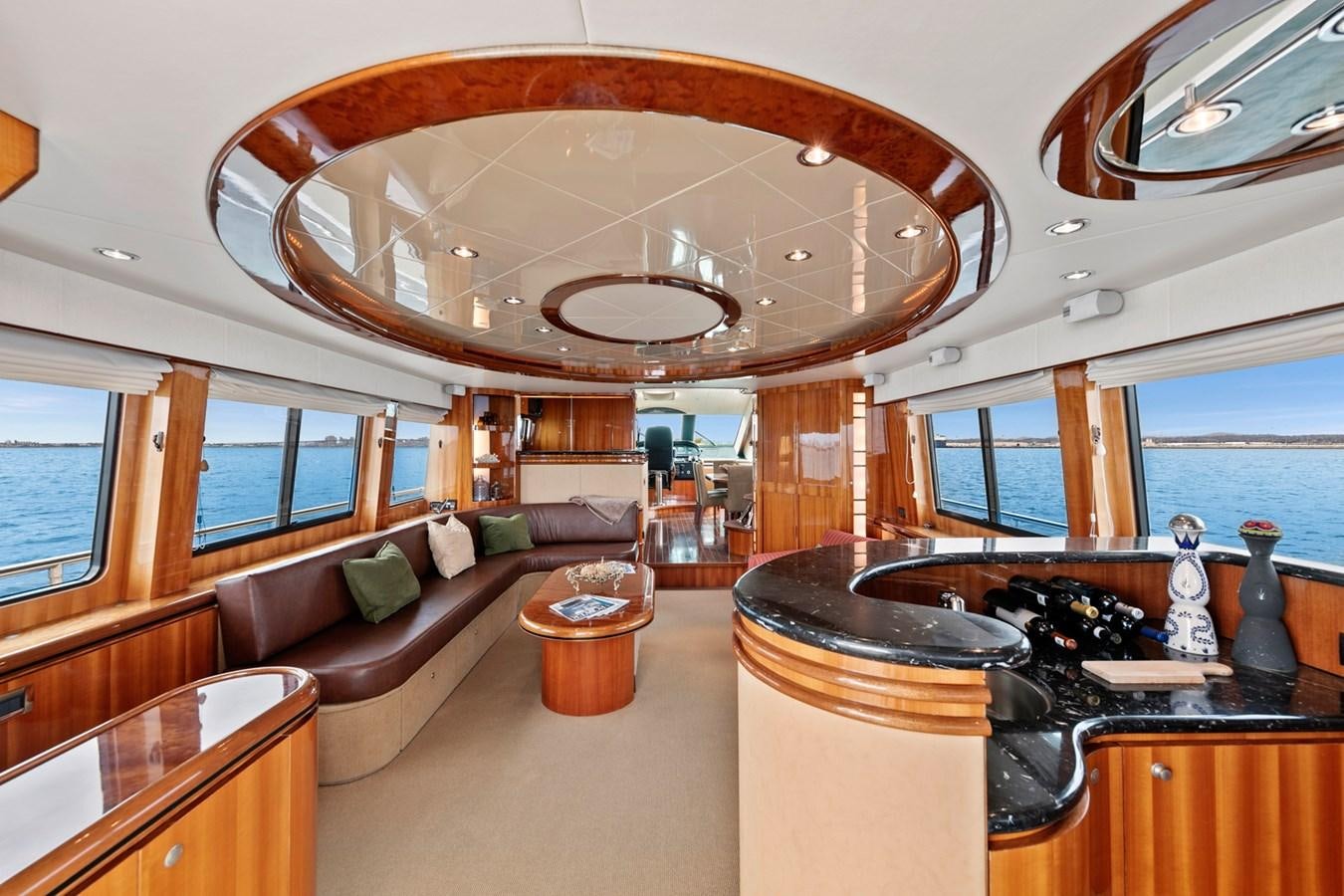 a large living room with a large chandelier aboard VAMOS A VER Yacht for Sale