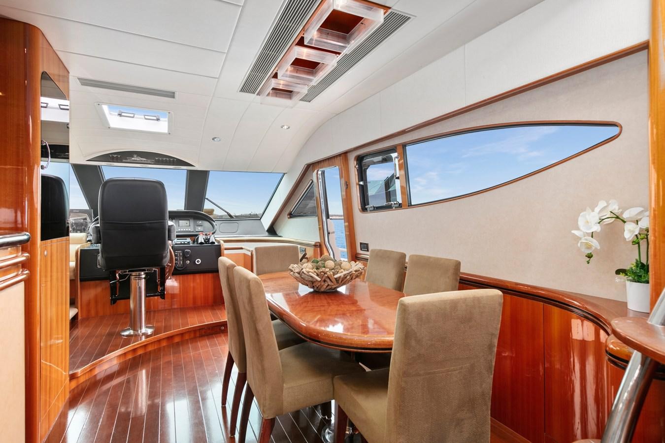 a room with a table and chairs aboard VAMOS A VER Yacht for Sale
