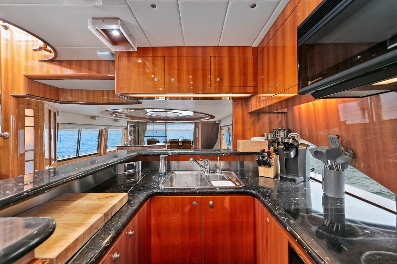 a kitchen with wooden cabinets aboard VAMOS A VER Yacht for Sale