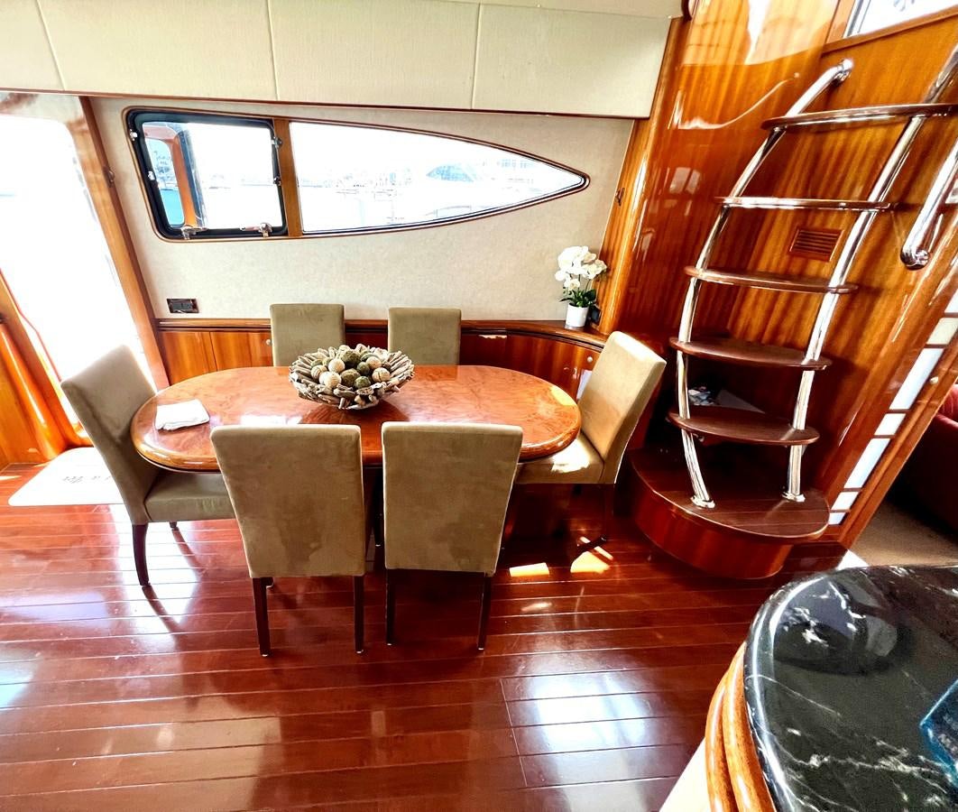 a dining table in a room aboard VAMOS A VER Yacht for Sale