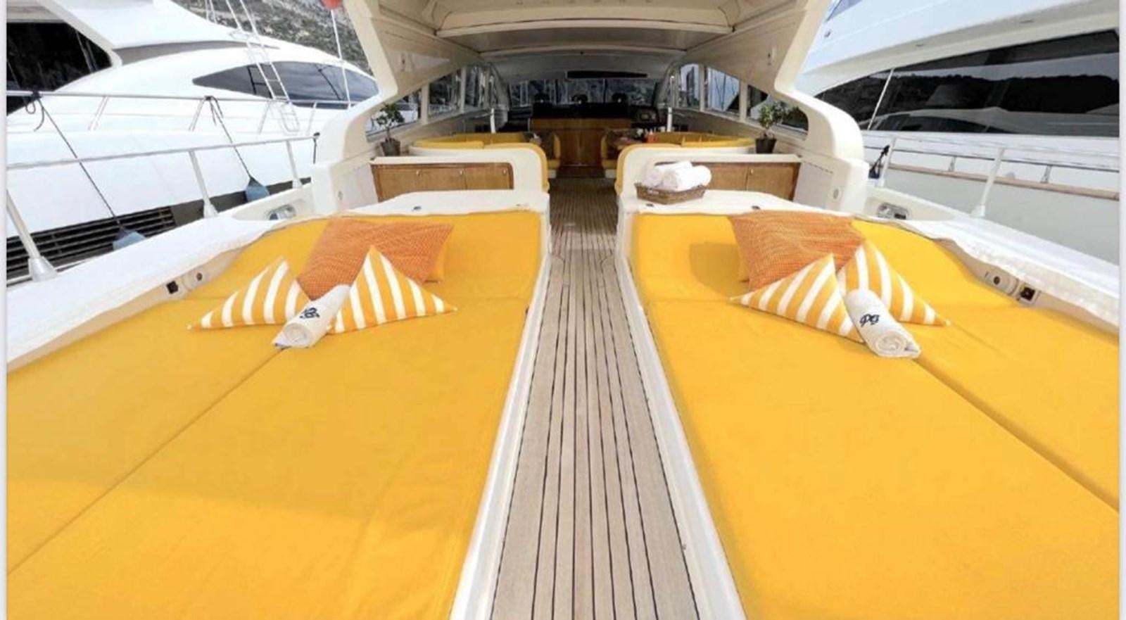 a room with a row of beds aboard DG Yacht for Sale