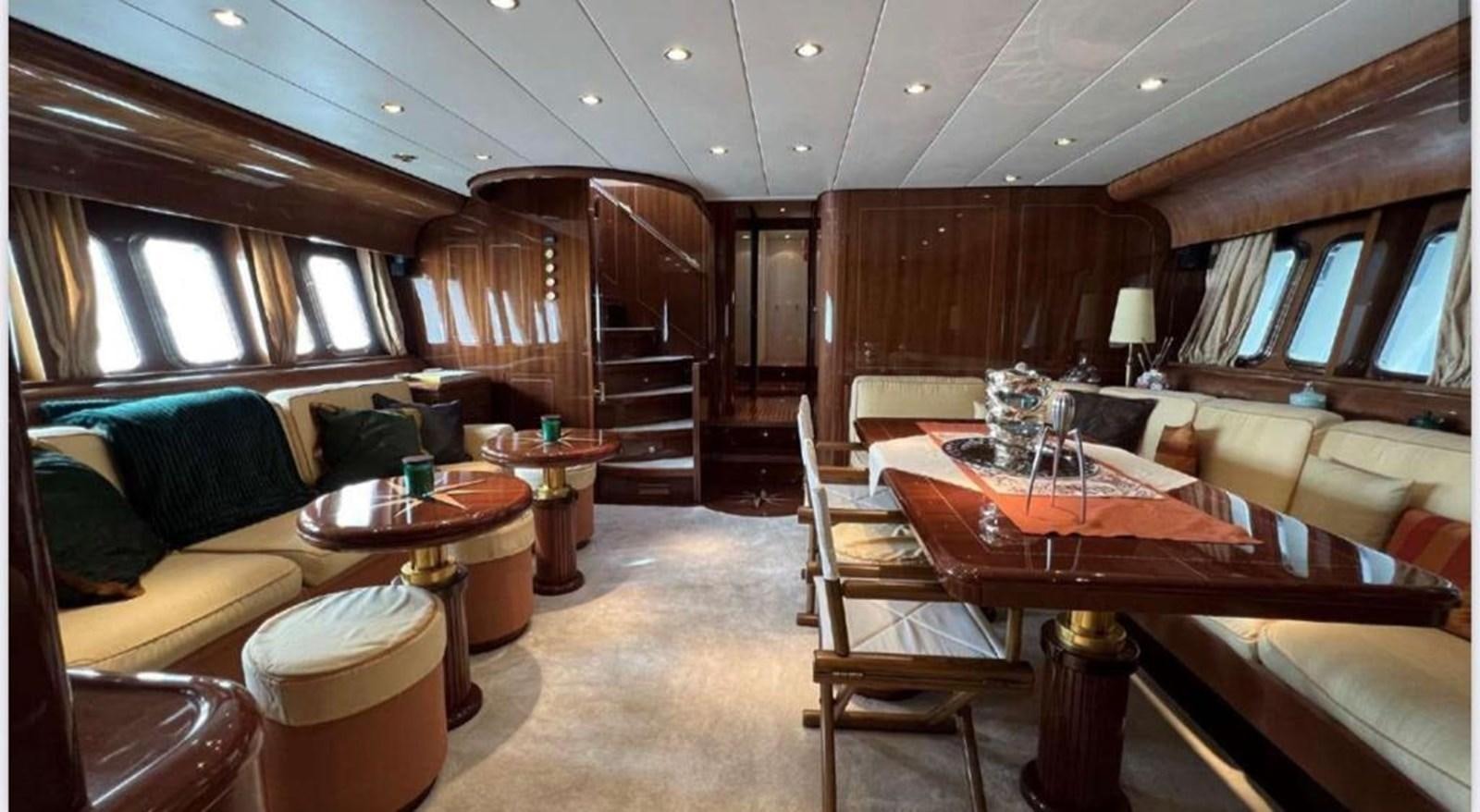 a room with a couch and a table and chairs aboard DG Yacht for Sale