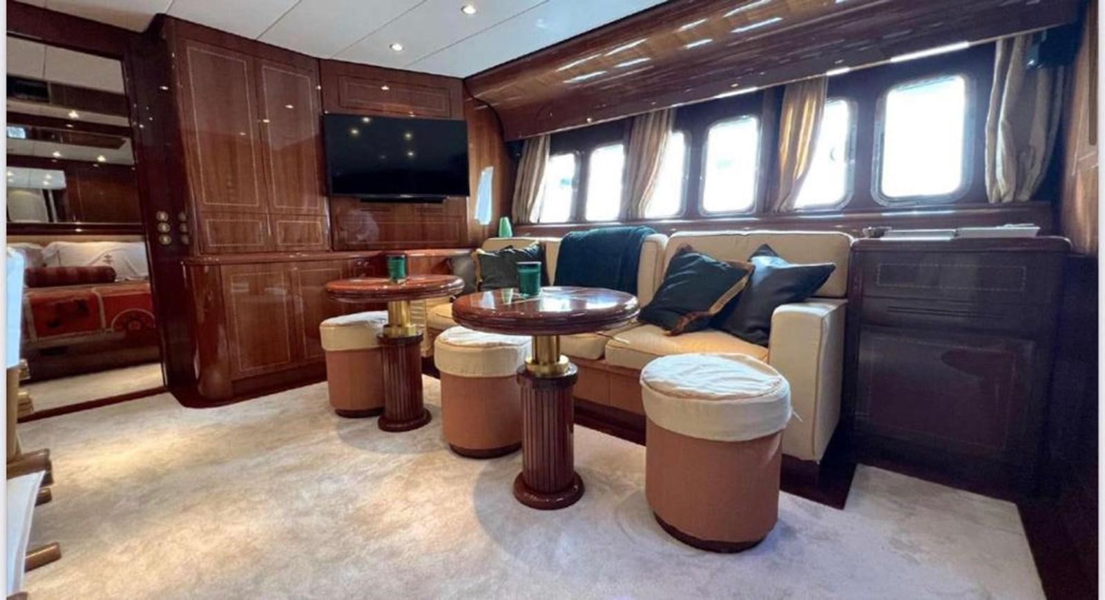 a living room with a couch and coffee table aboard DG Yacht for Sale