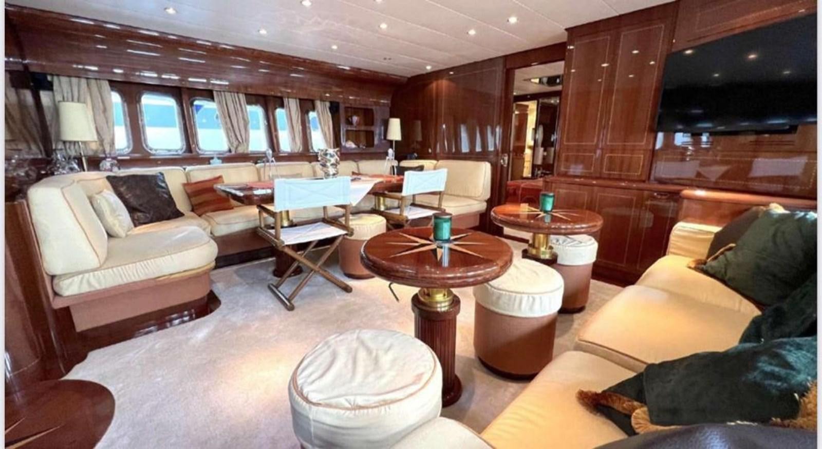 a living room with a couch and a coffee table aboard DG Yacht for Sale