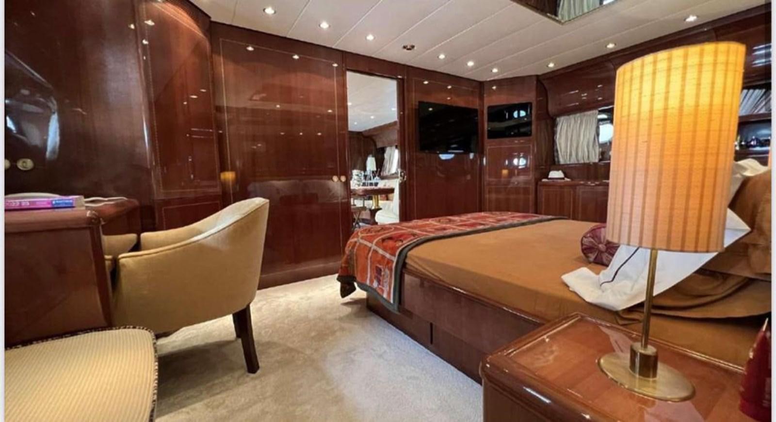 a room with a bed and a chair aboard DG Yacht for Sale