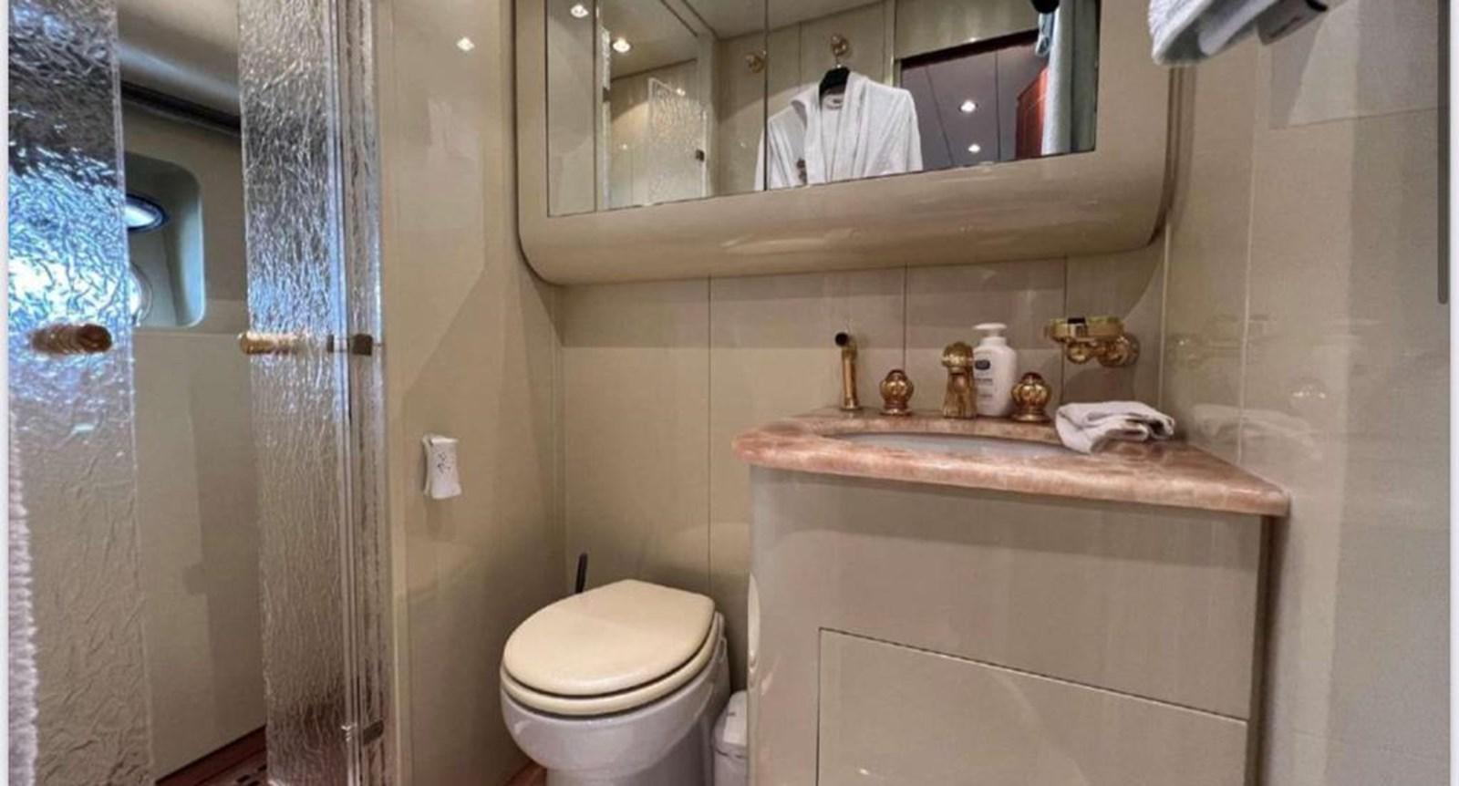 a bathroom with a sink toilet and a mirror aboard DG Yacht for Sale