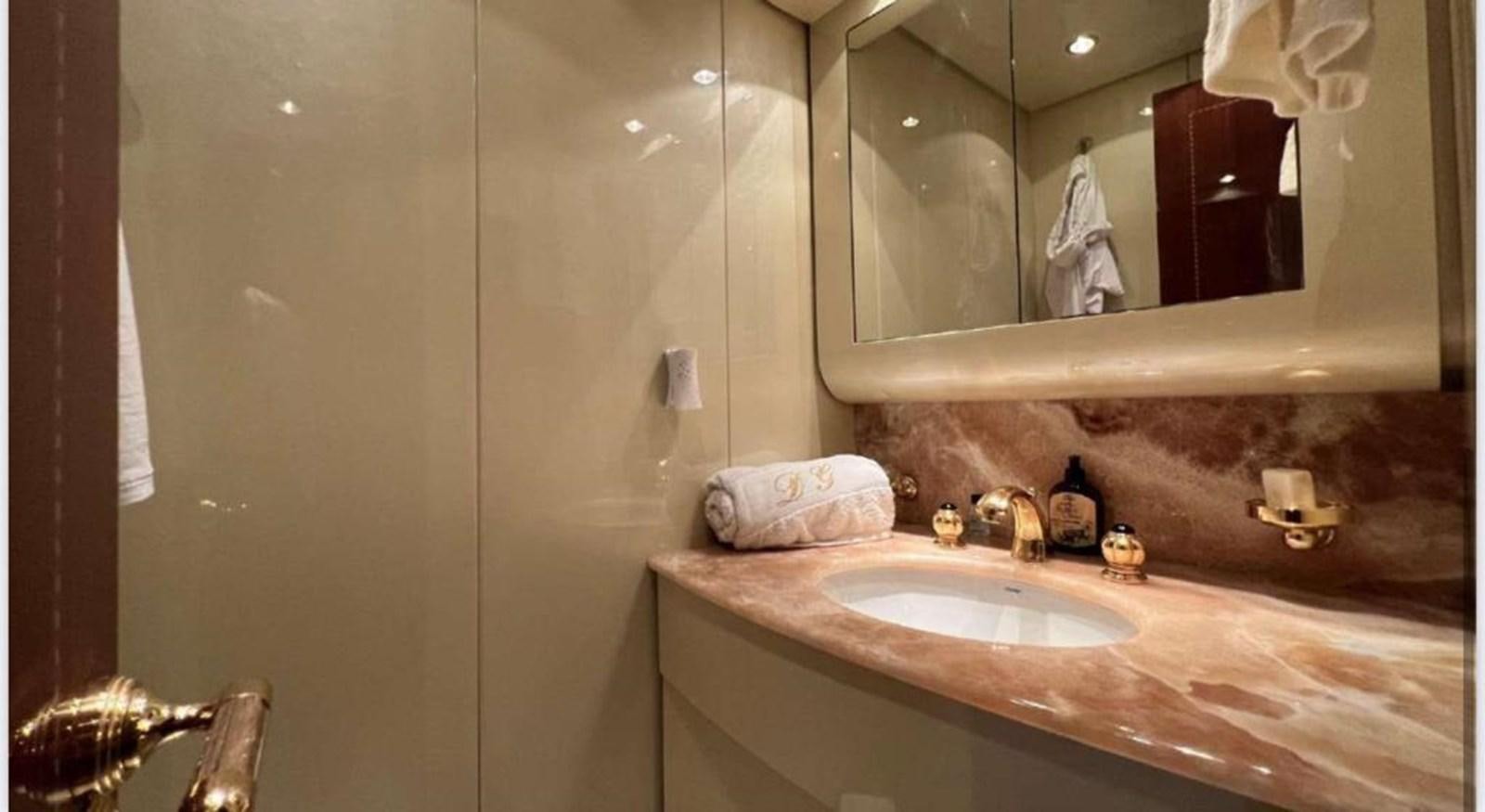 a bathroom with a large mirror aboard DG Yacht for Sale
