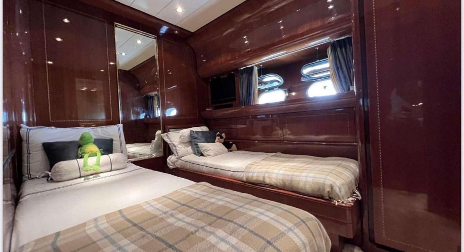 a room with a bed and a stuffed toy aboard DG Yacht for Sale