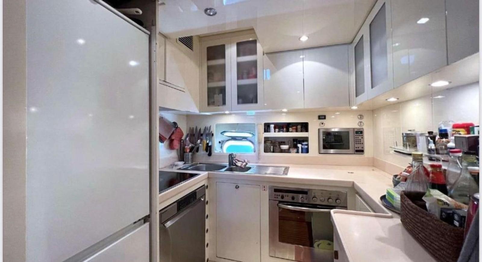 a kitchen with white cabinets aboard DG Yacht for Sale