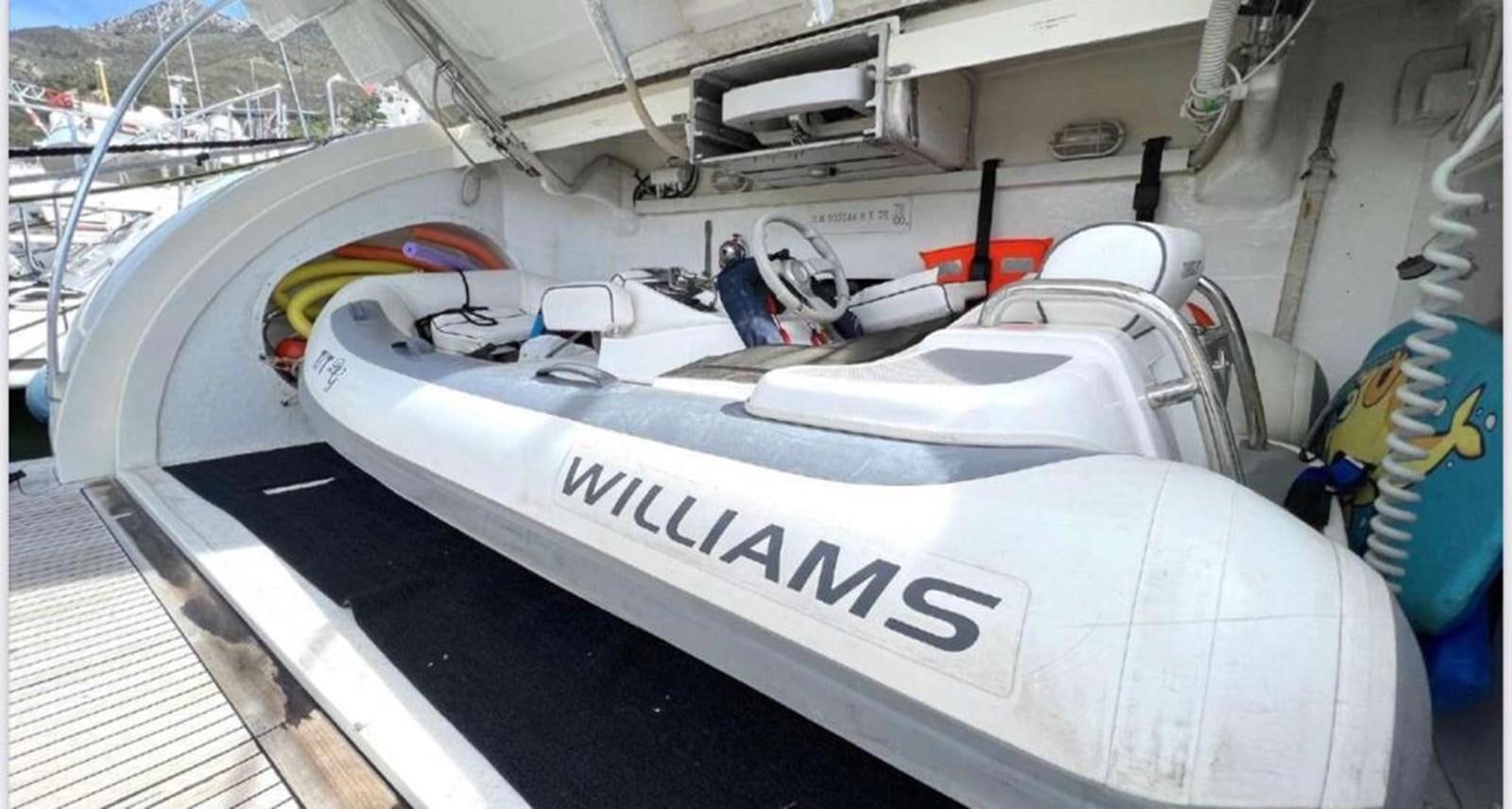 a white car with a black and red stripe on the front aboard DG Yacht for Sale