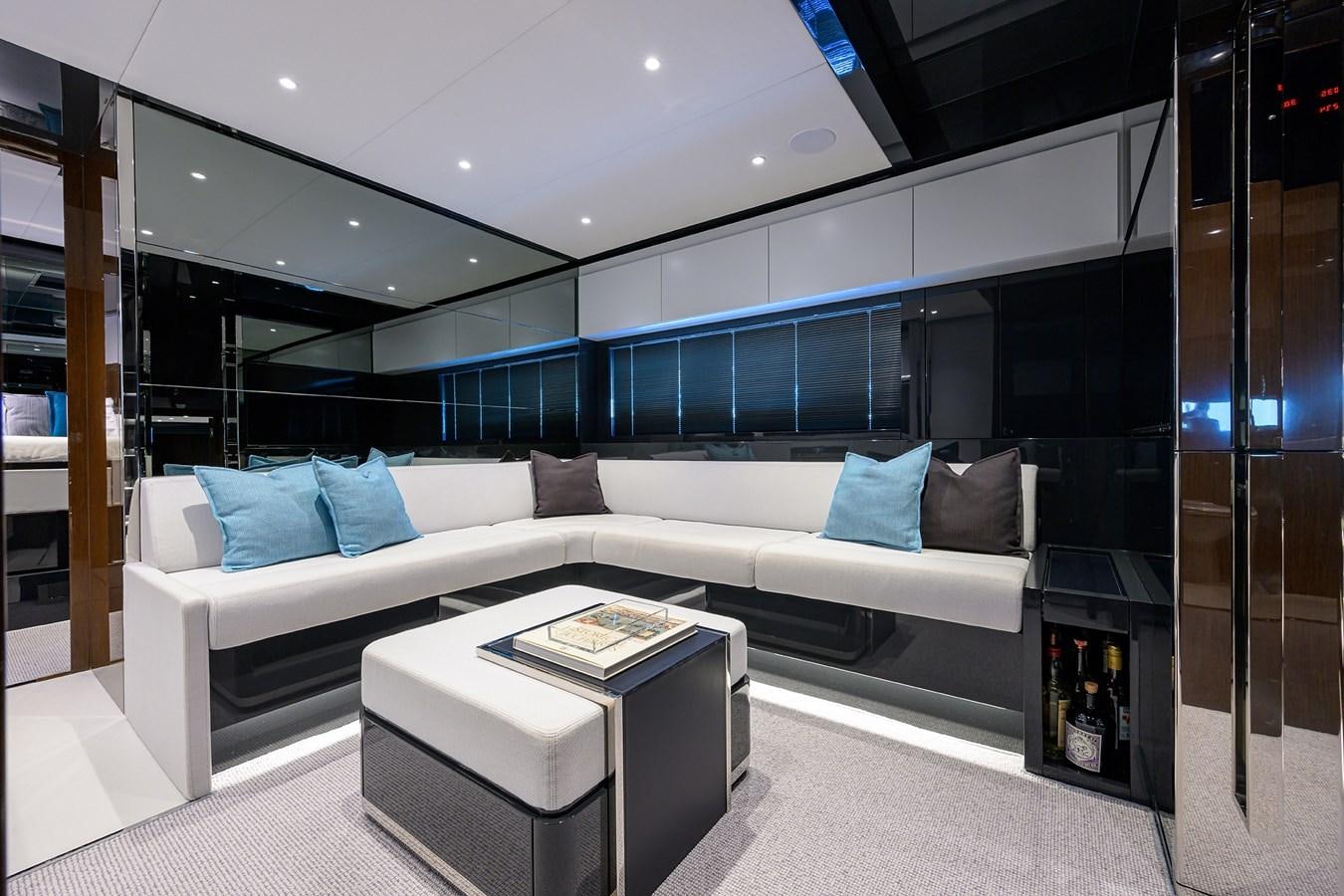 a room with a couch and a table aboard JACQPOT Yacht for Sale
