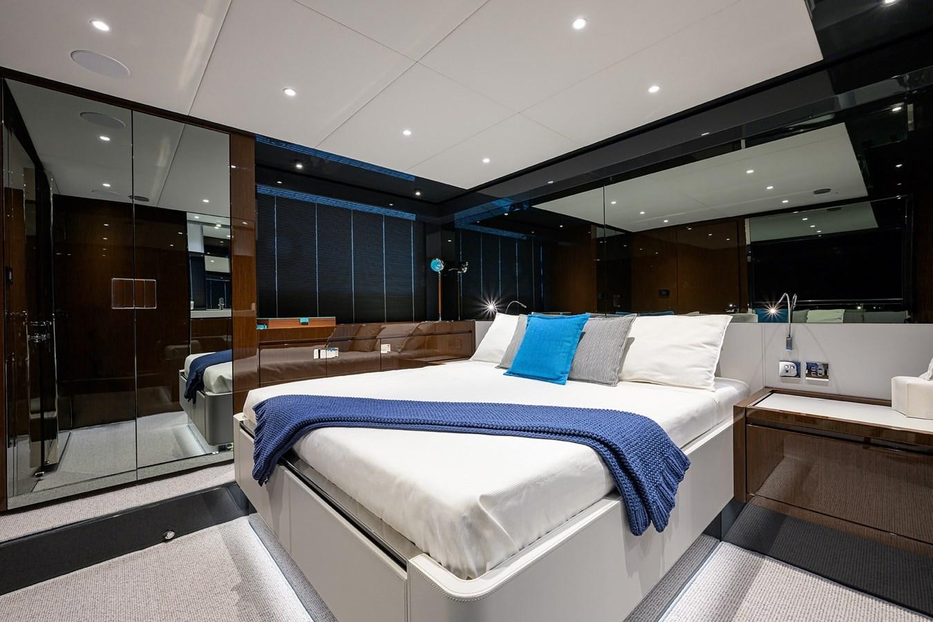 a room with a bed and a glass door aboard JACQPOT Yacht for Sale