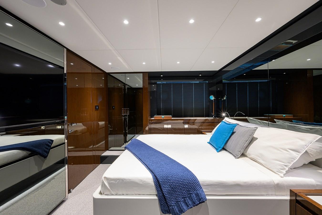 a room with a bed and a large mirror aboard JACQPOT Yacht for Sale