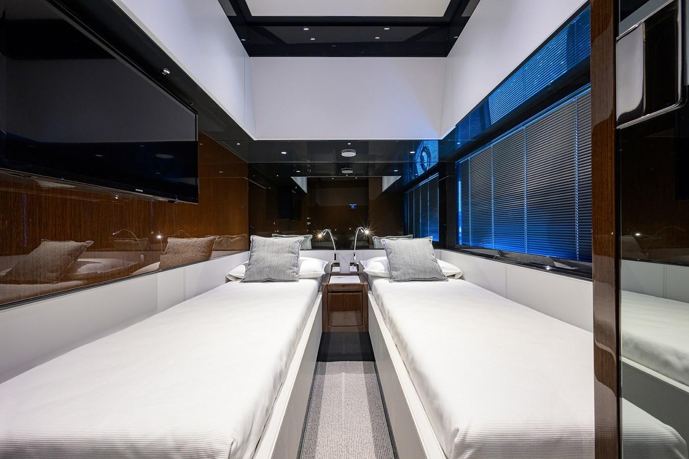 a room with a couple of beds aboard JACQPOT Yacht for Sale