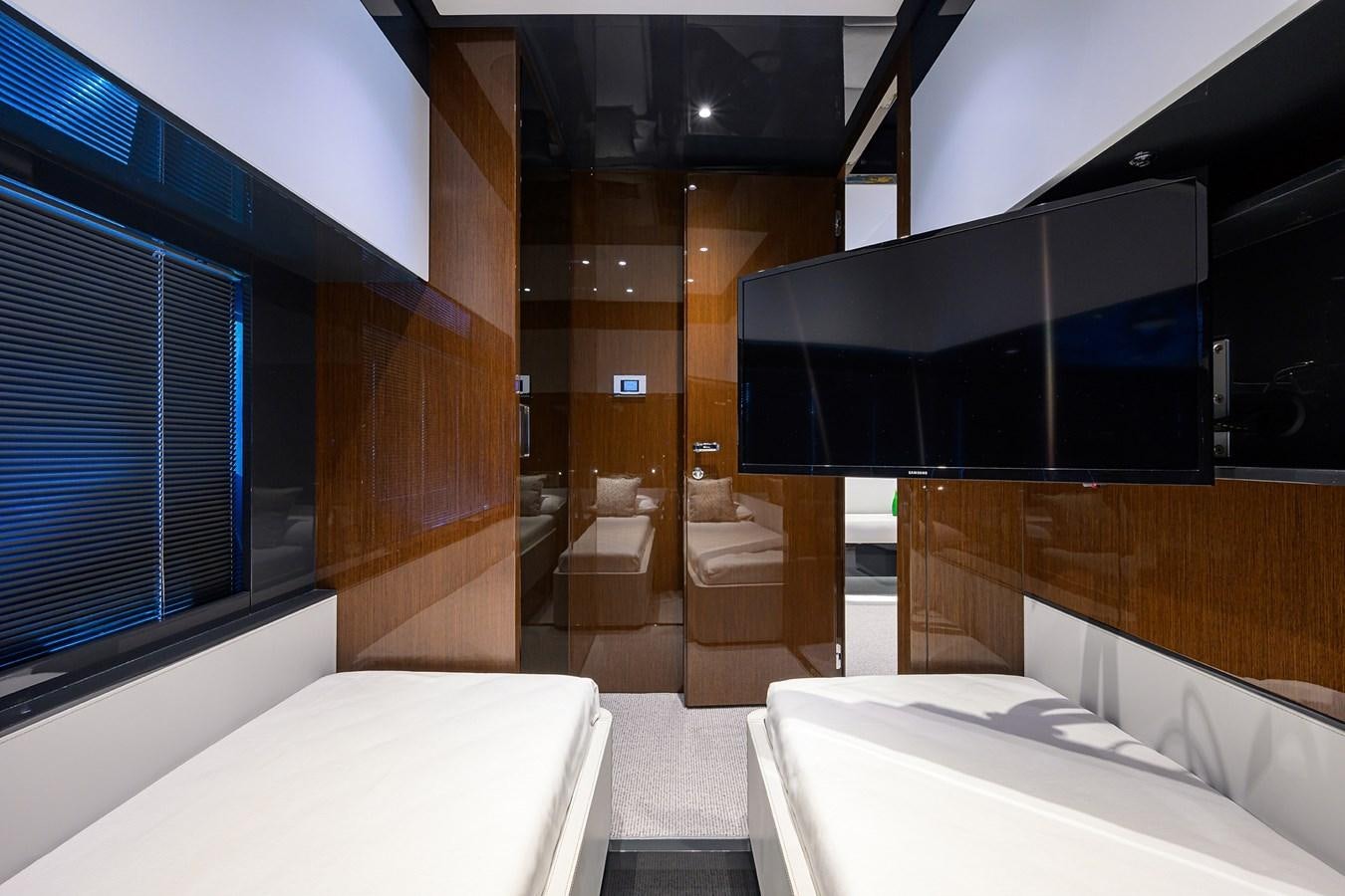 a room with a bed and a window aboard JACQPOT Yacht for Sale