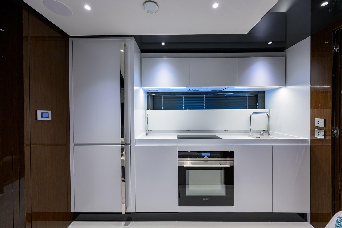 a kitchen with a refrigerator and a sink aboard JACQPOT Yacht for Sale