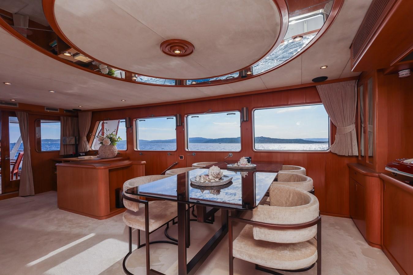 a dining room with a table aboard SISSI Yacht for Sale