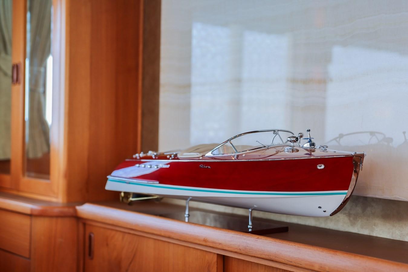 a red and blue boat on a window sill aboard SISSI Yacht for Sale