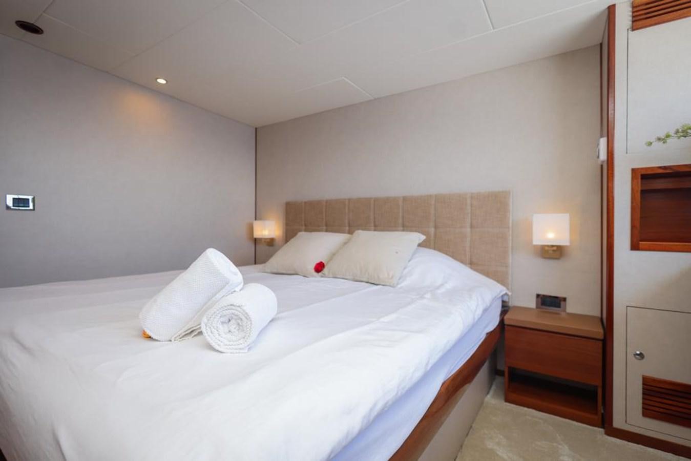 a bed with white sheets aboard SISSI Yacht for Sale