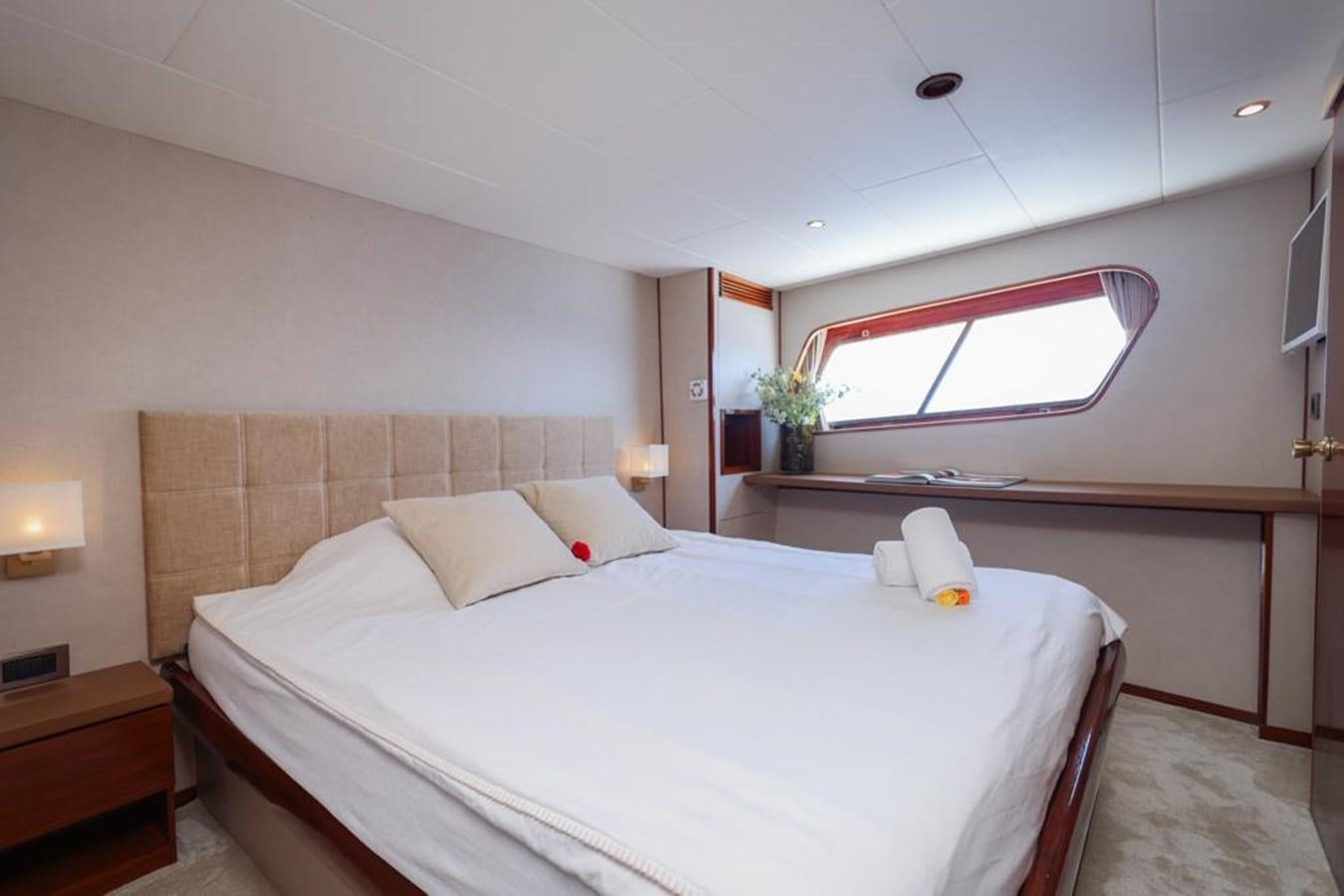 a room with a bed and a window aboard SISSI Yacht for Sale