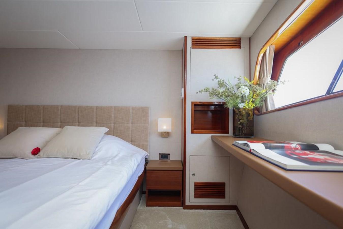 a bedroom with a desk and a bed aboard SISSI Yacht for Sale