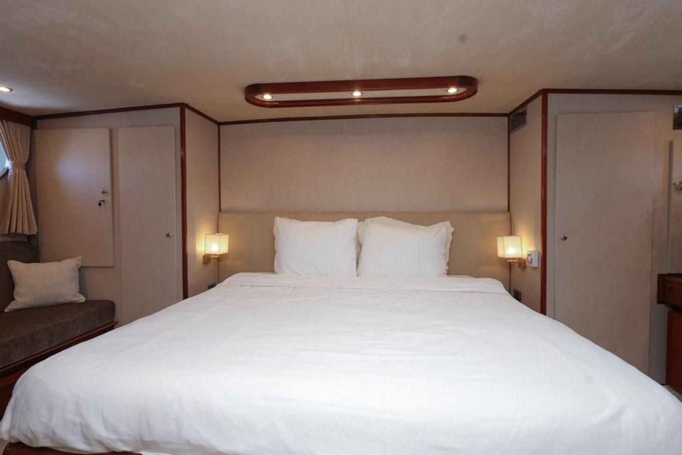 a bed with white sheets aboard SISSI Yacht for Sale