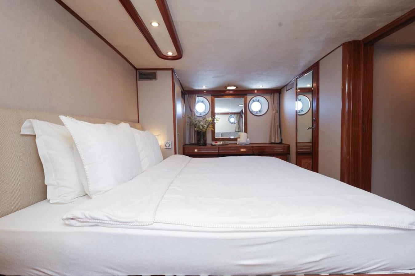 a bed with white sheets aboard SISSI Yacht for Sale