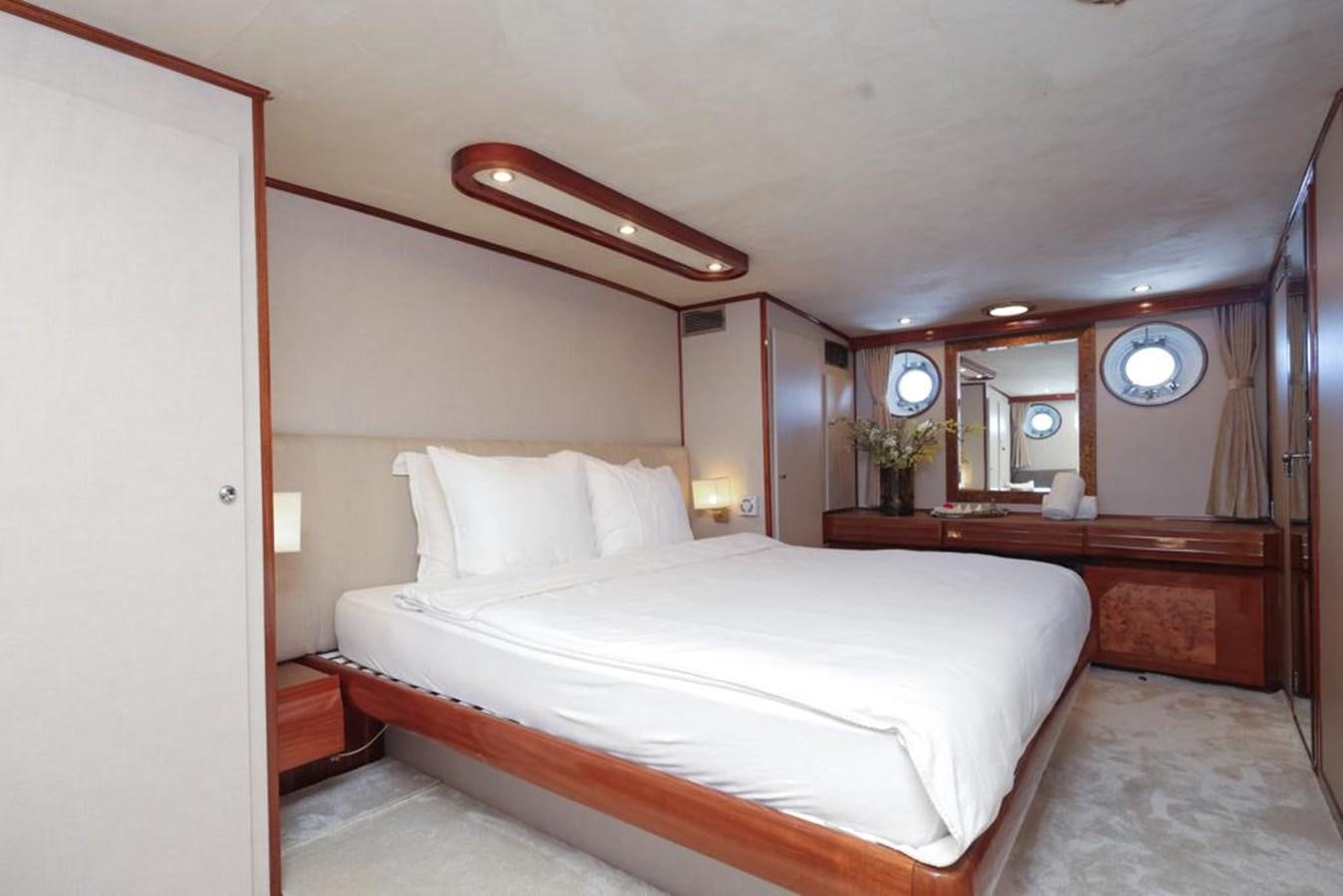 a bedroom with a bed and a mirror aboard SISSI Yacht for Sale