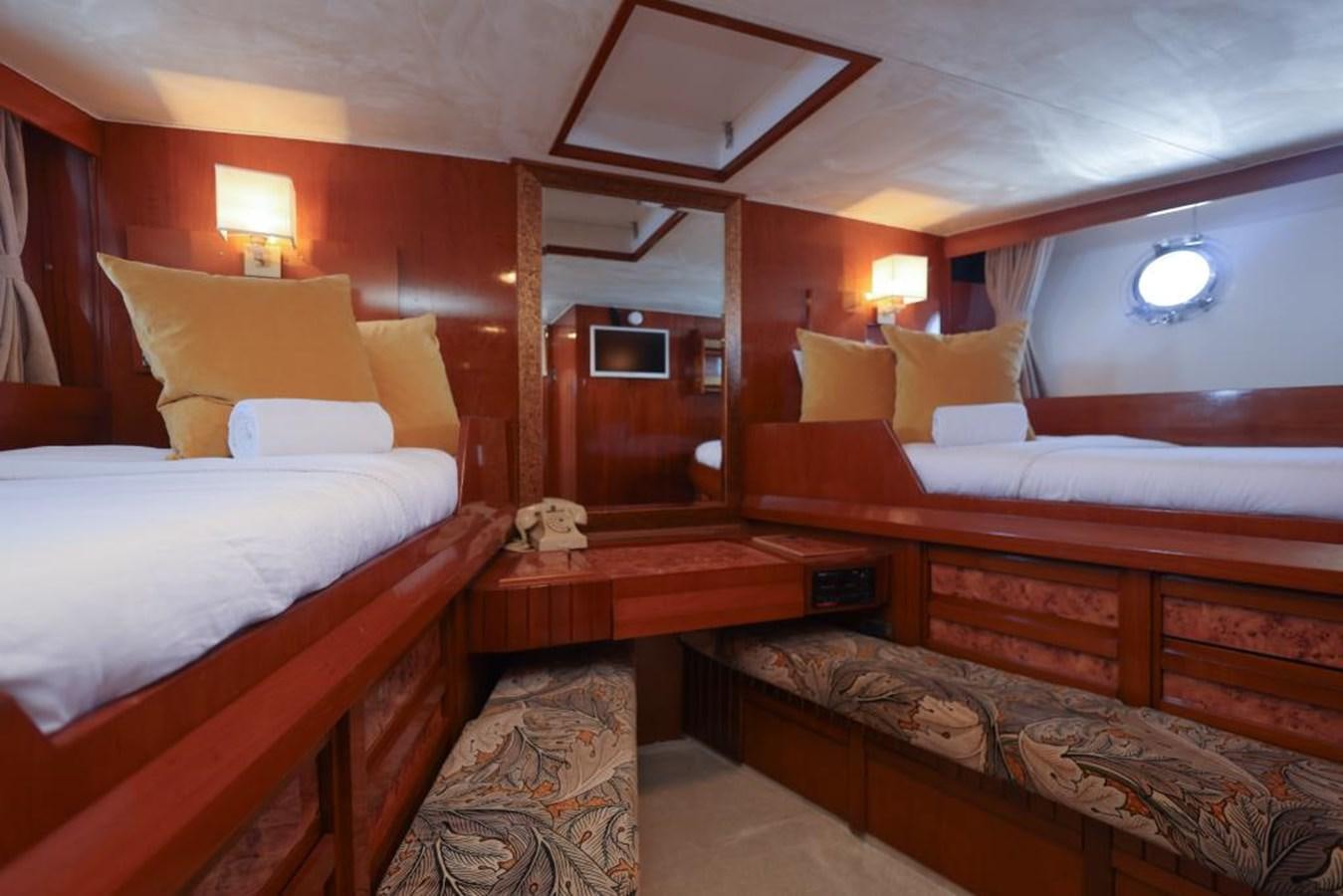 a room with beds and a mirror aboard SISSI Yacht for Sale