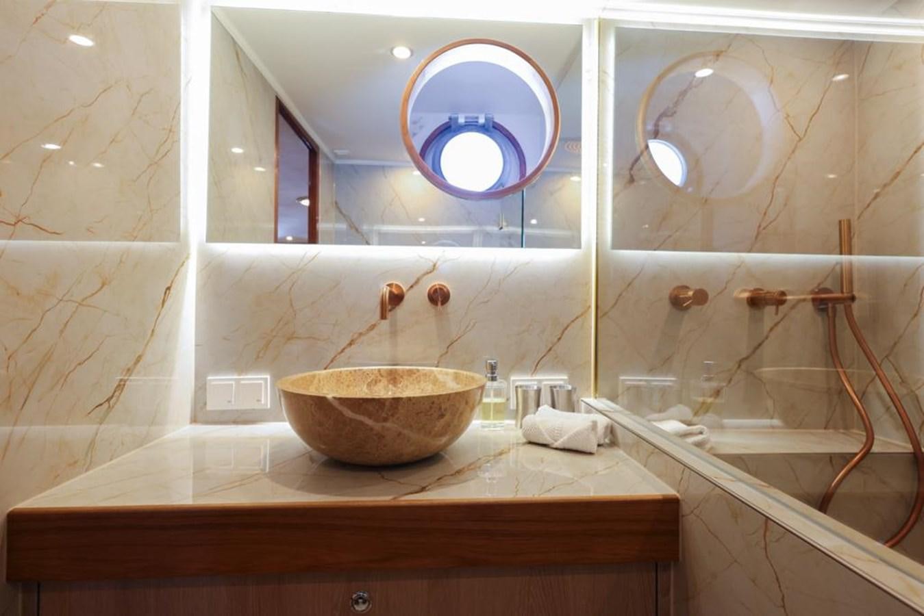 a bathroom with a round mirror aboard SISSI Yacht for Sale