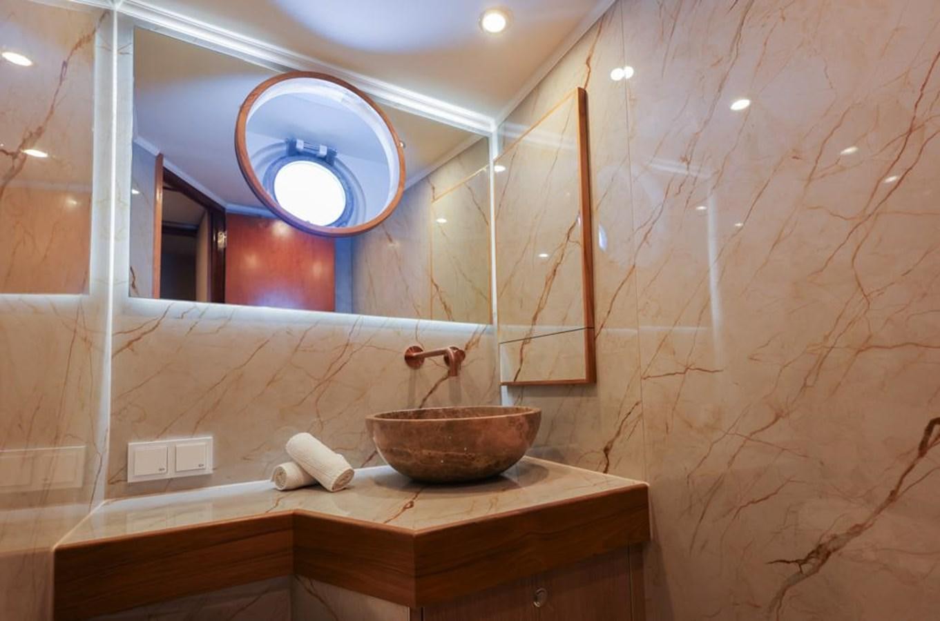 a bathroom with a round mirror aboard SISSI Yacht for Sale
